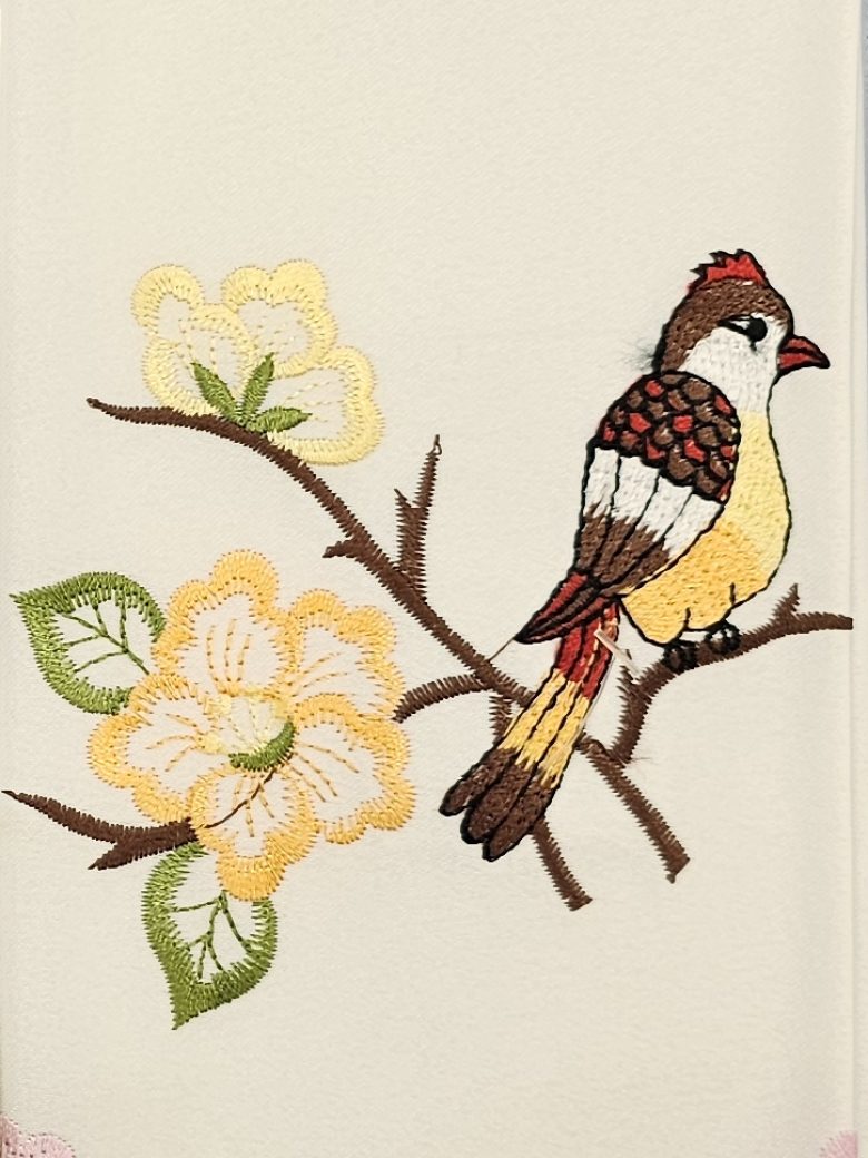 Ivory guest towel embroidered with a goldfinch on a blossom branch