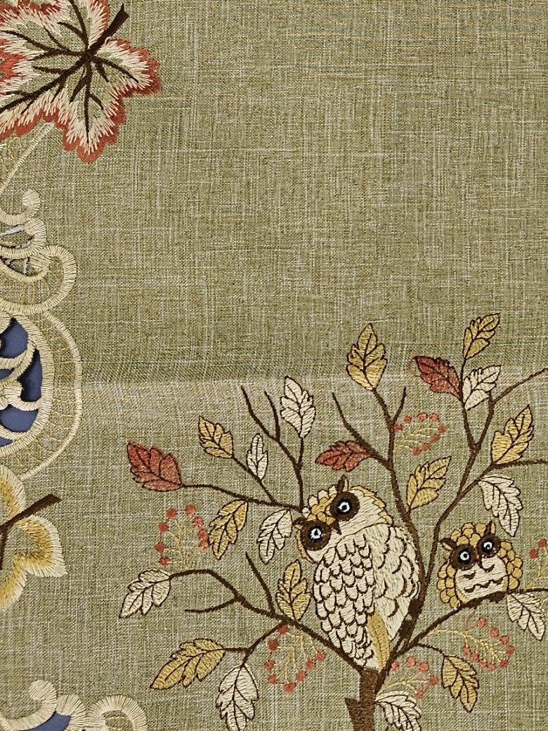 Olive linen table runner embroidered with owls on an autumn branch and a cutwork leaf border