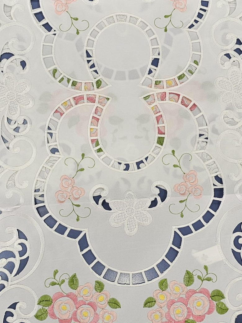 White table runner with mosaic cutwork medallions and pink rose embroidery