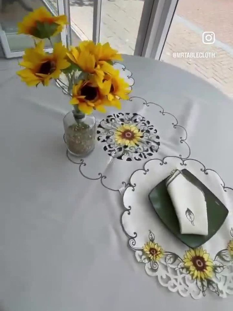 Dressing a round table with a sunflower tablecloth in our Willemstad shop